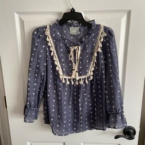 Mauve shirt with Pom Pom details. Size small